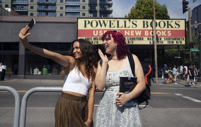 Students taking a selfie in front of Powell's Books.