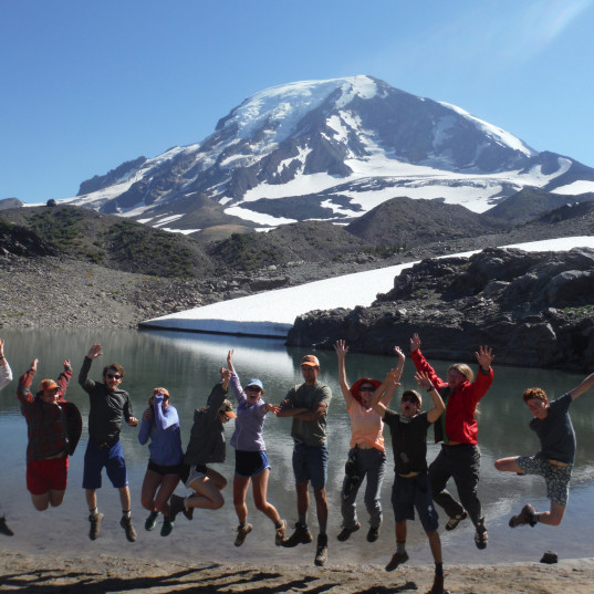 College Outdoors participants jumping with Mt Hood in the background