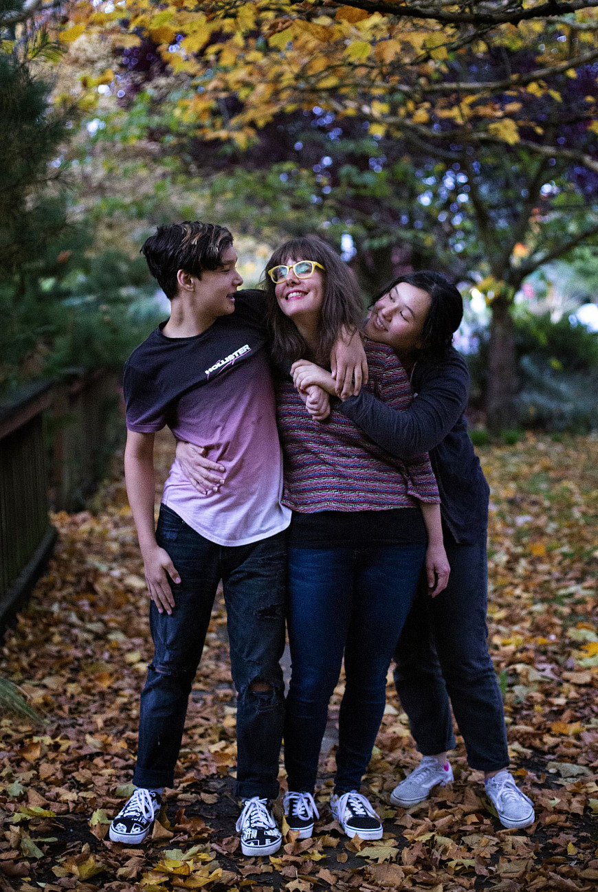 Stacey Kim, center, with her twins, Riley, left, and Maddie, 13, in Portland, Ore. They were 10 months old when their father, John, died ...