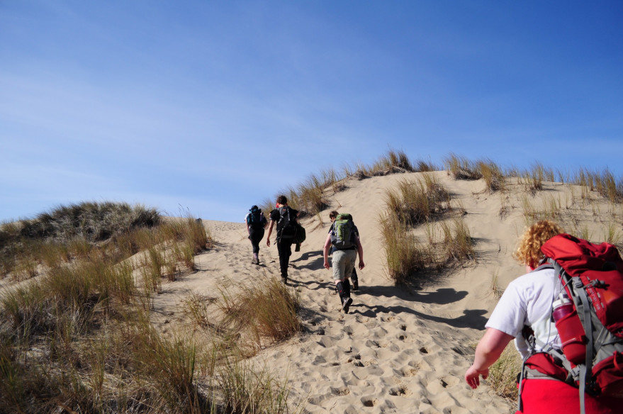 Students on a hike over sand dunes at the Oregon coast