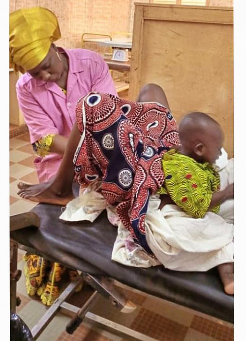 Midwife conducting vaginal screening.