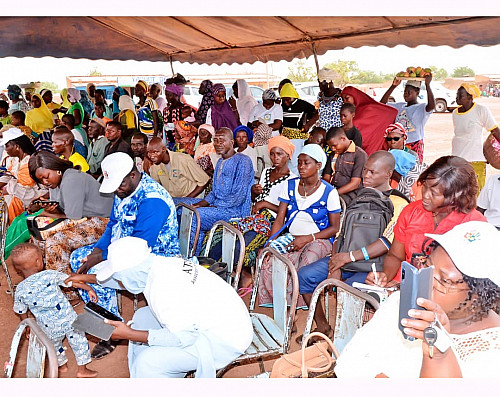 Opening ceremony of the screening campaign with attendees seated under a tent.