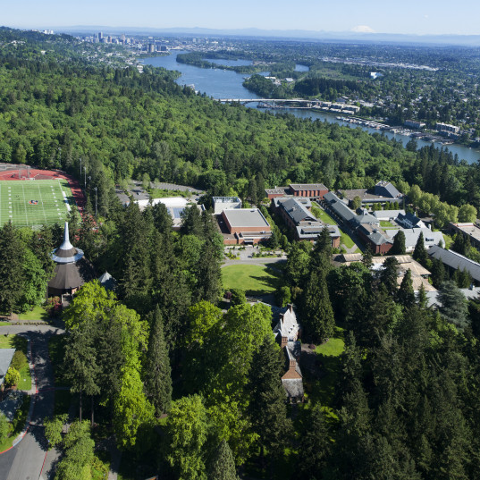 Aerial view of the campus with Portland in the background.