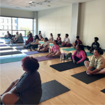 Students attend an HWI yoga session in 2024 to address mental health while existing in a space for social justice.