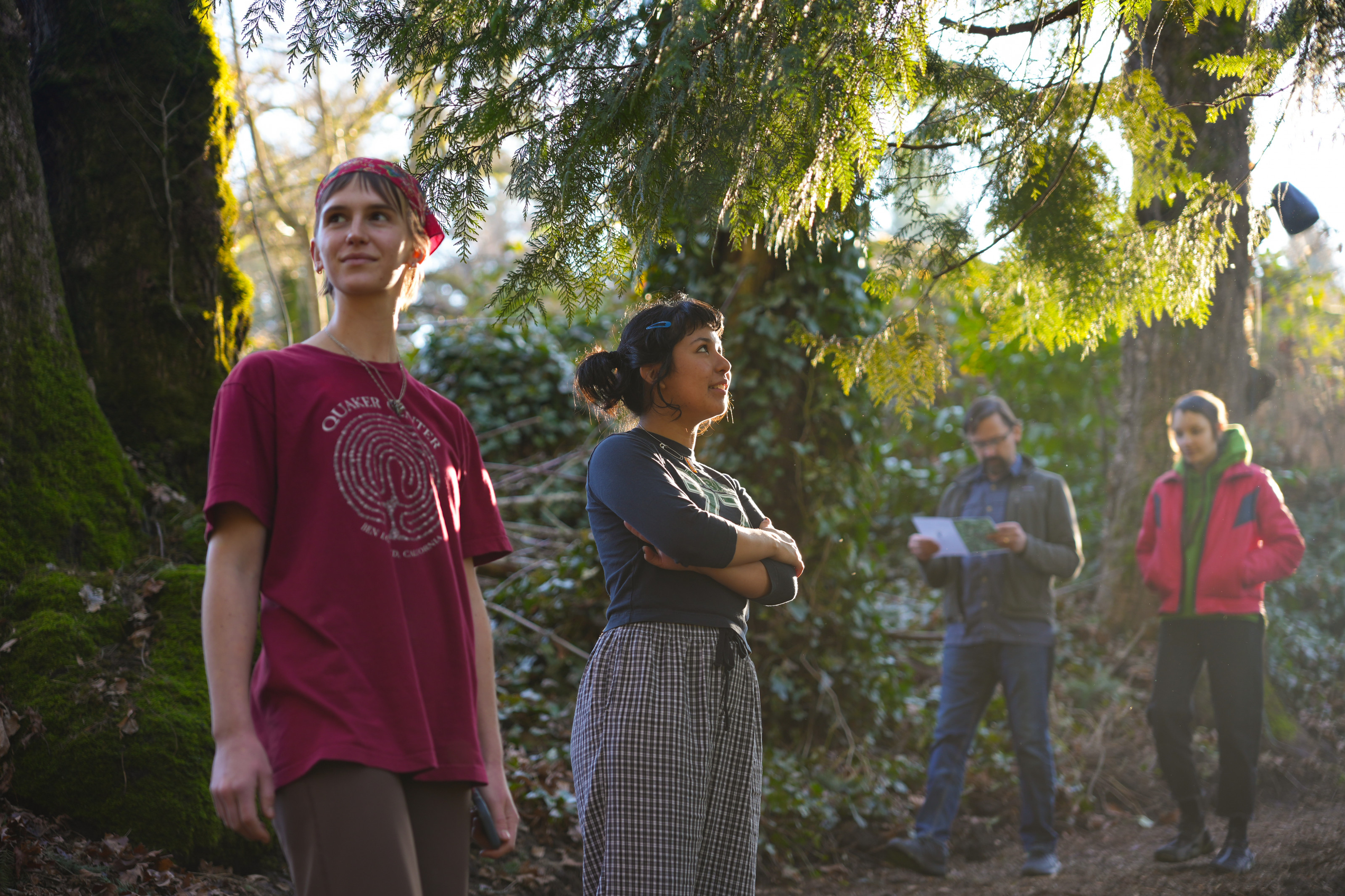 Students standing in a forest.