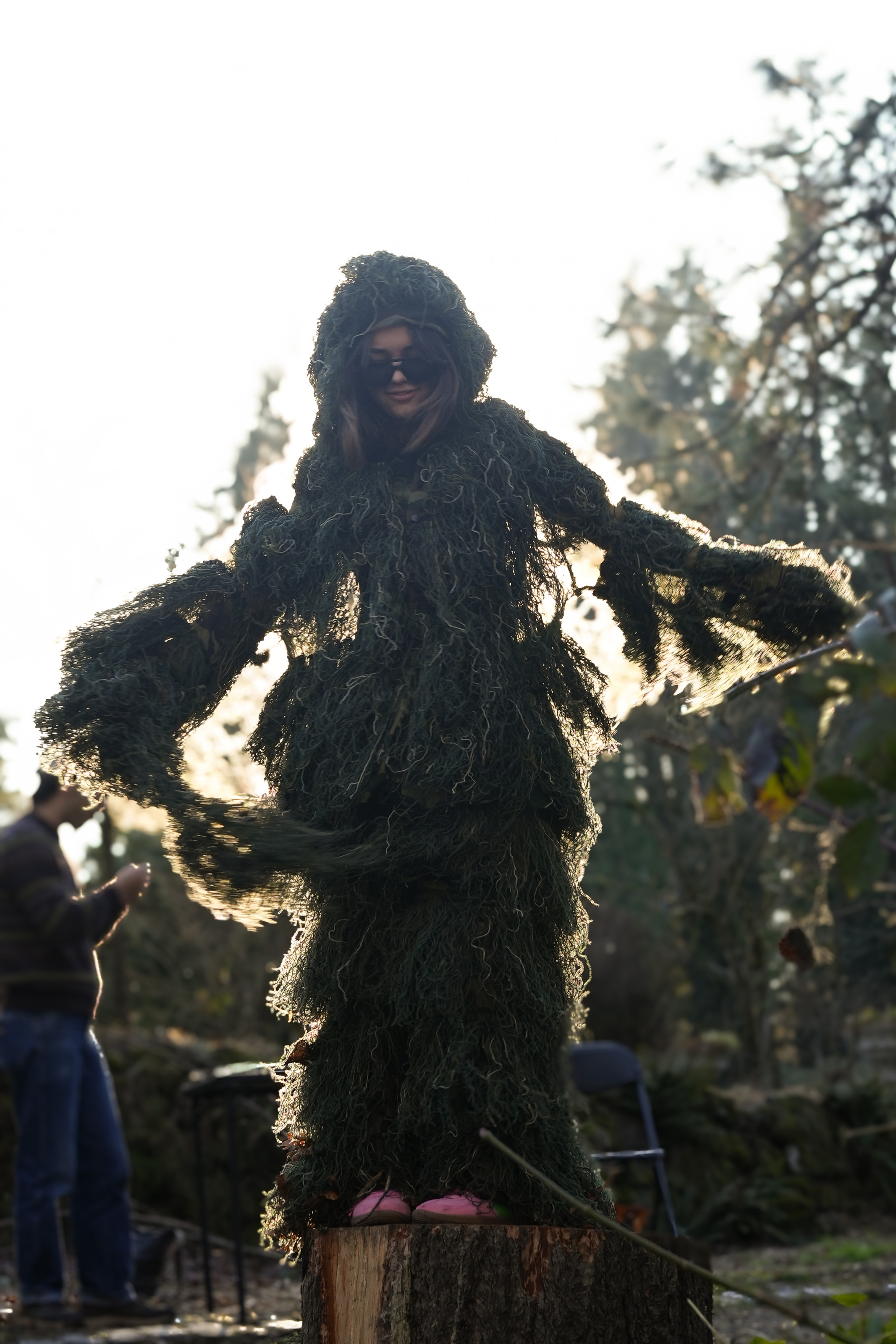 A student wearing a full-body moss suit.