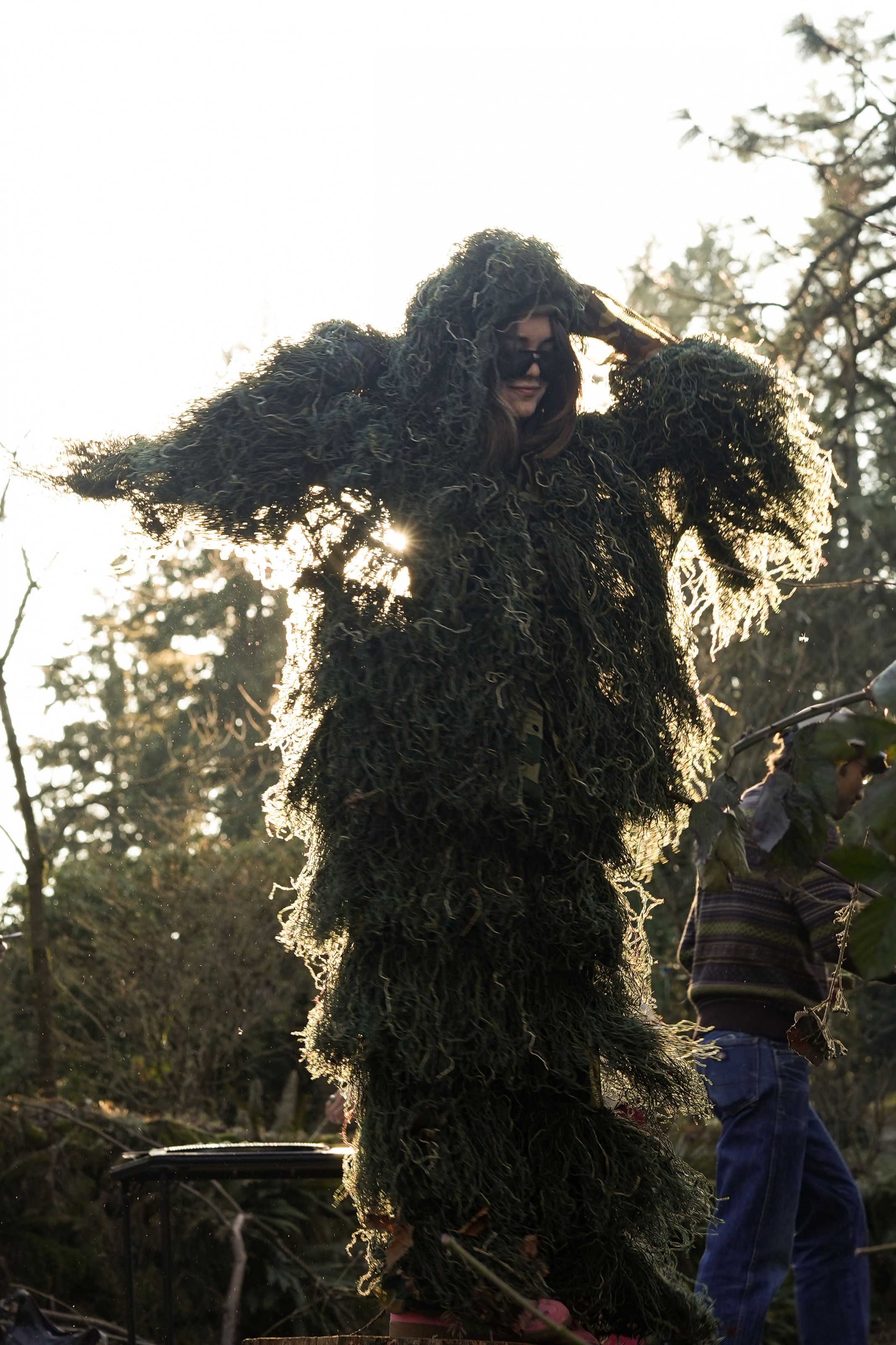 A student wearing a full-body moss suit.