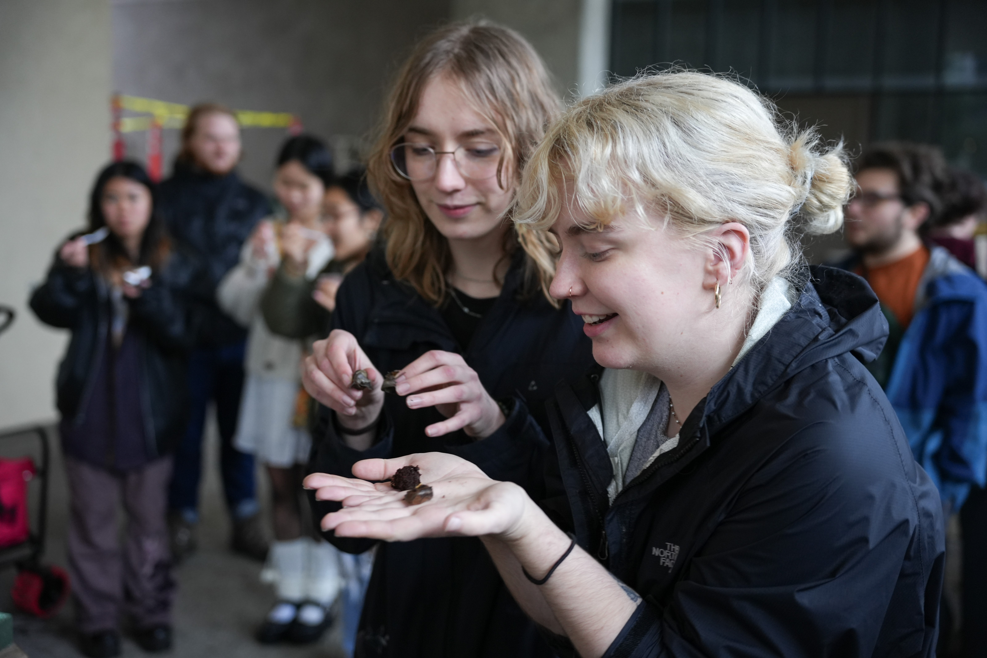 Students holding slugs in their palms.