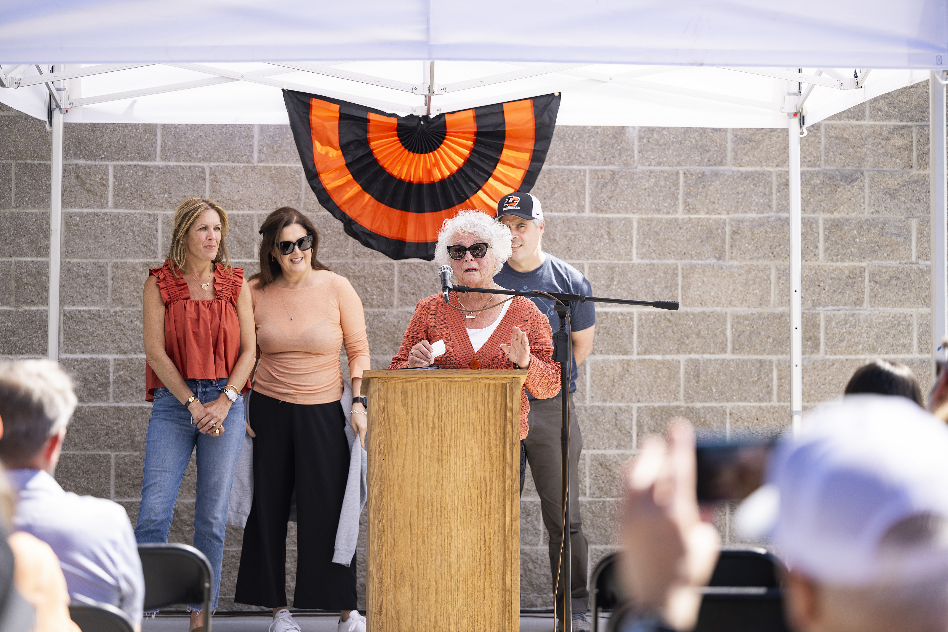 Carol Gatto (Jerry's wife) speaking during the dedication, with kids Michelle Fritts, Chrissy Davis, and Steve Gatto standing behind her.