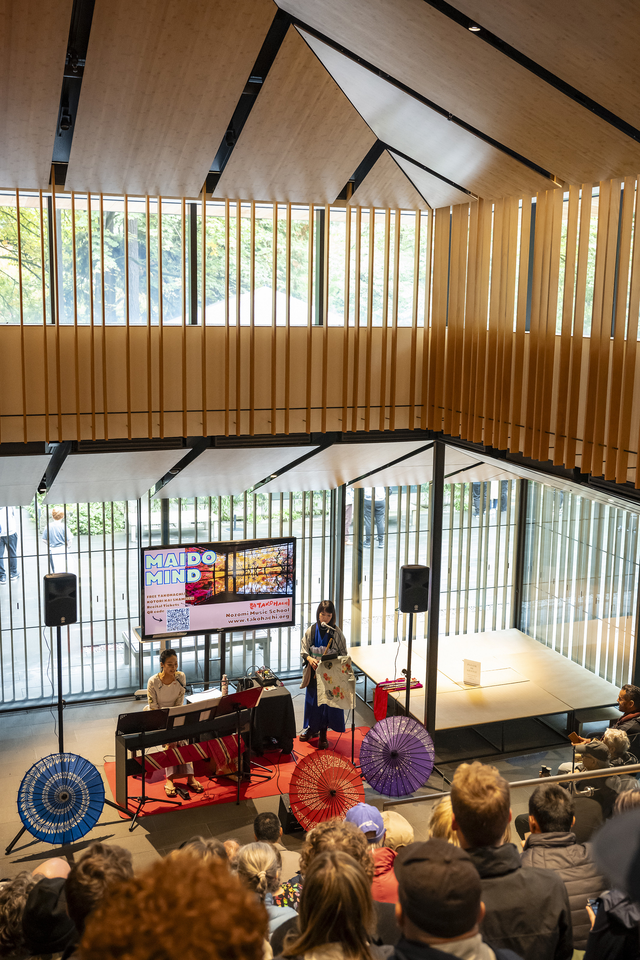 Two performers on stage with an audience watching.