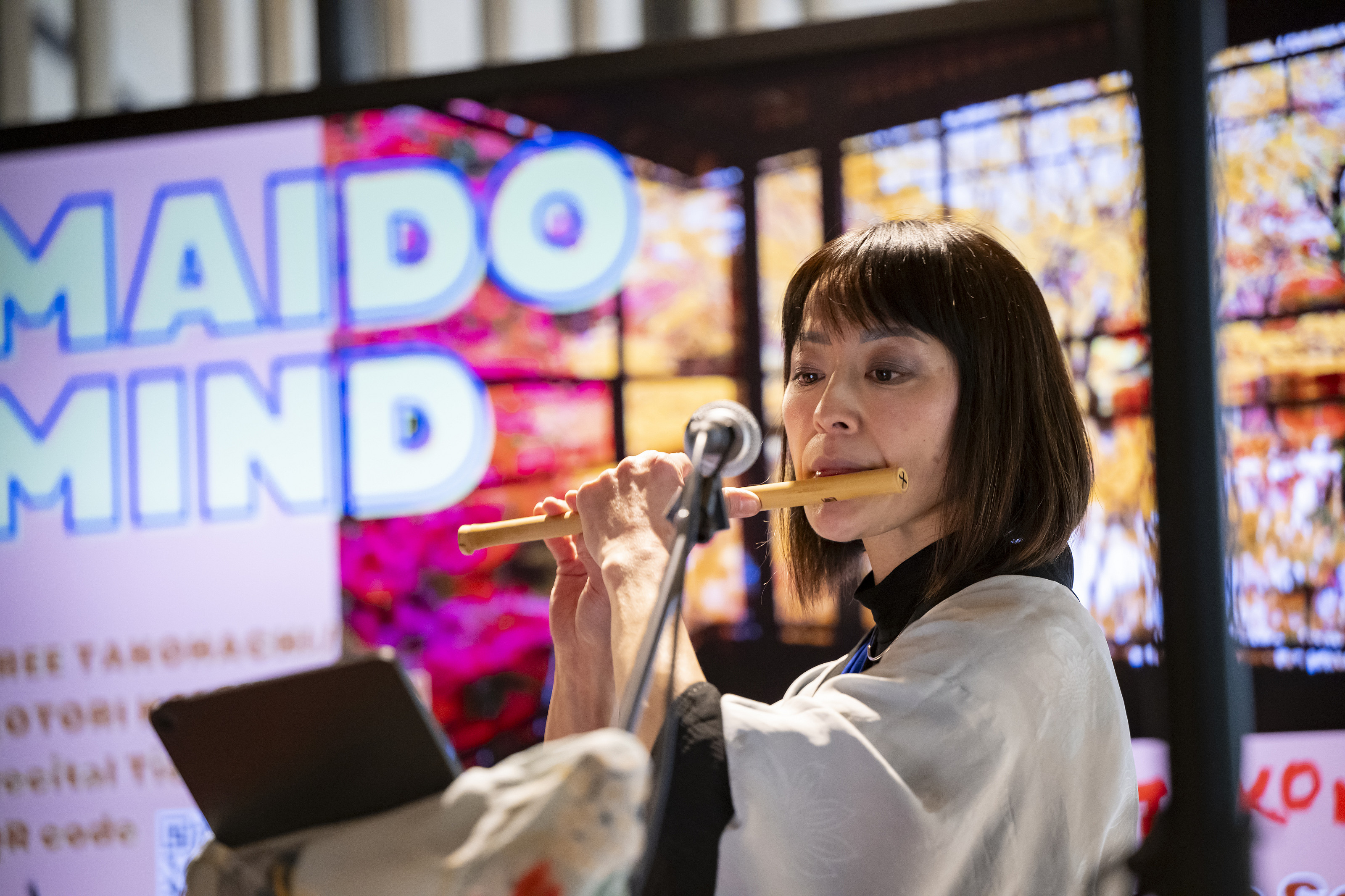 A close-up of a performer using a Japanese musical instrument.