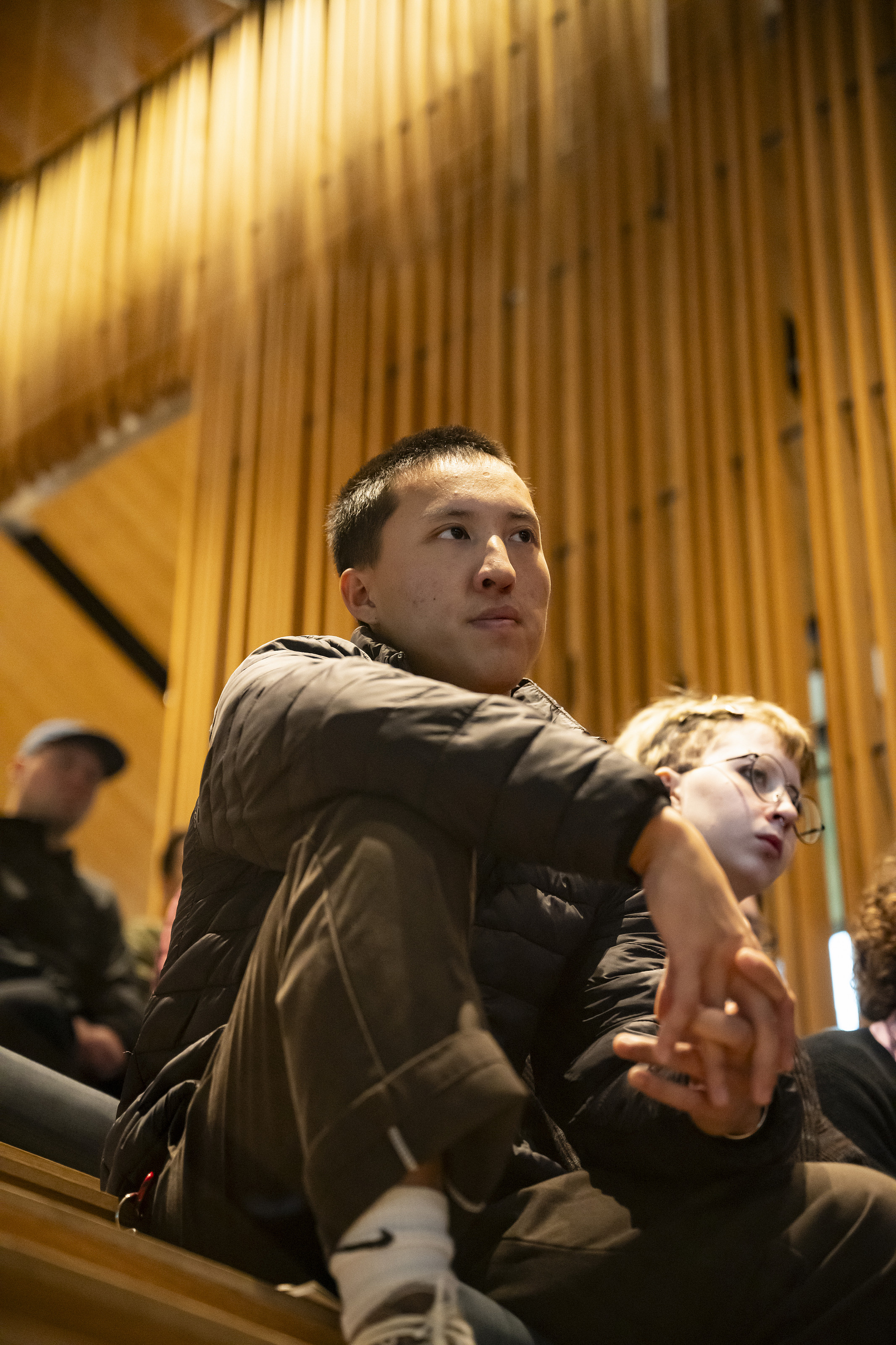 A student watching the musical performance.