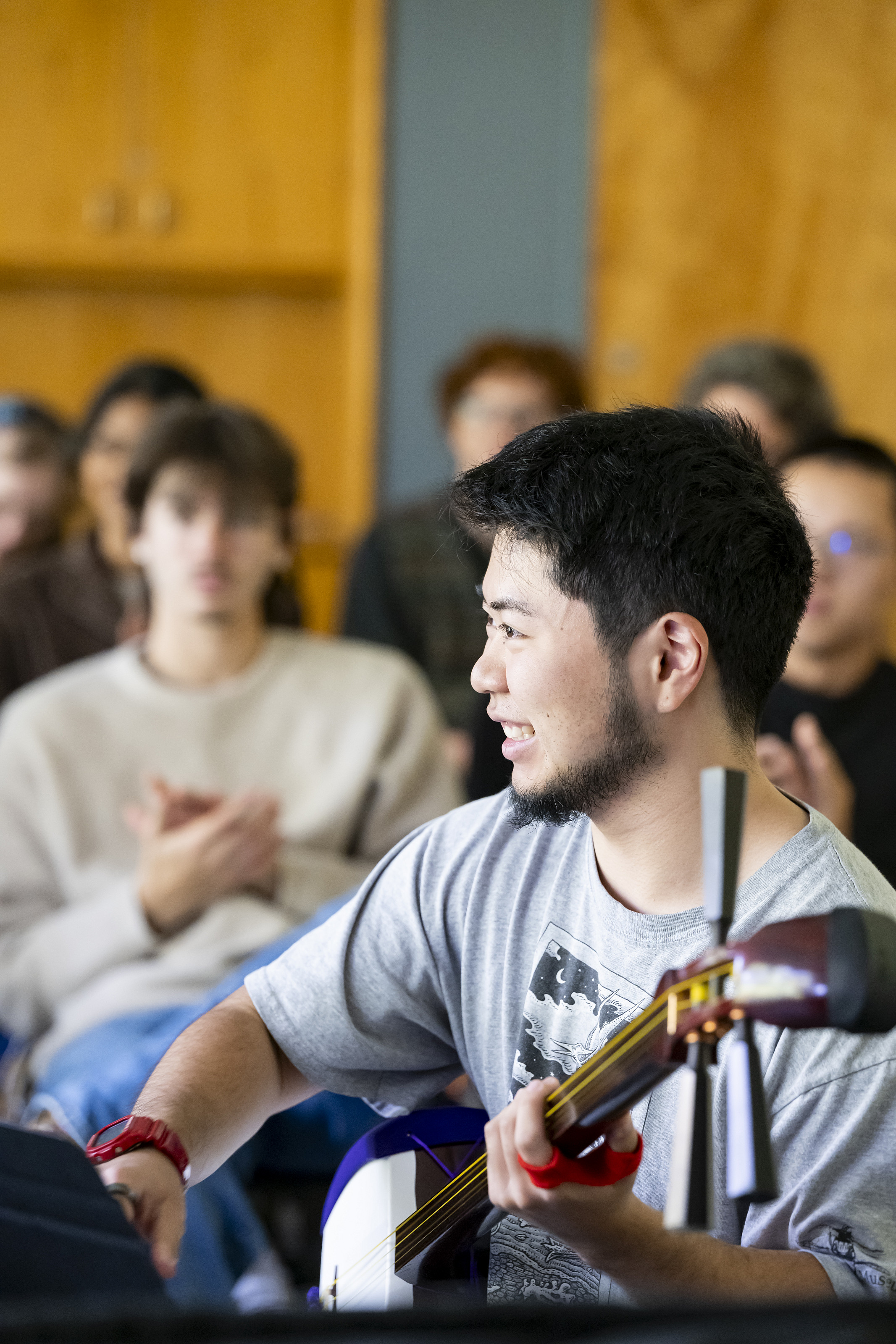 A performer playing a Japanese instrument.