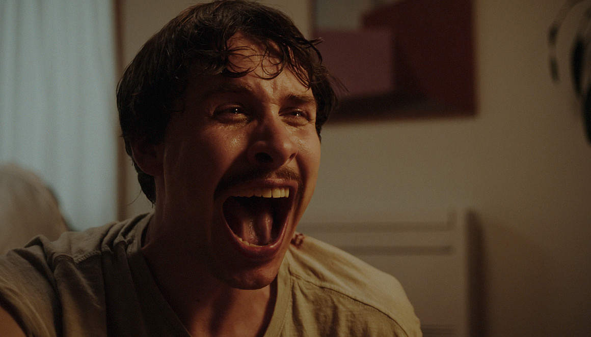 A close-up shot of a man screaming.