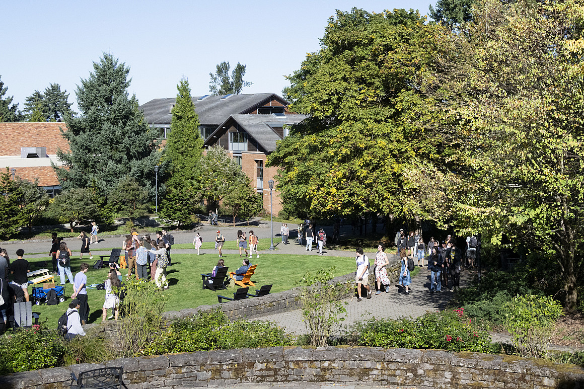 Students sitting on the Glade and walking around on campus.