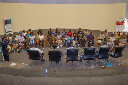 Participants sitting in front of six panelists.