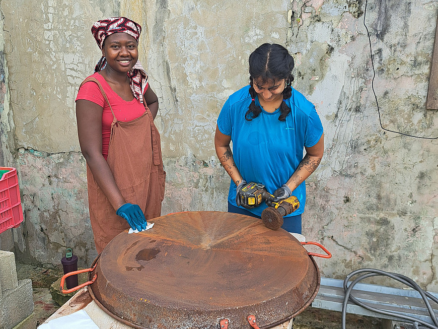 Students buff out paella pans with the organization Tenedor Social. (Puerto Rico)
