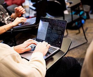 A student typing on a laptop.